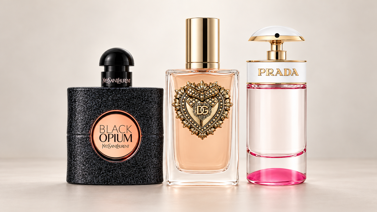 Yves Saint Laurent Black Opium, Dolce & Gabbana Devotion, and Prada Candy Kiss perfume bottles on a neutral background.