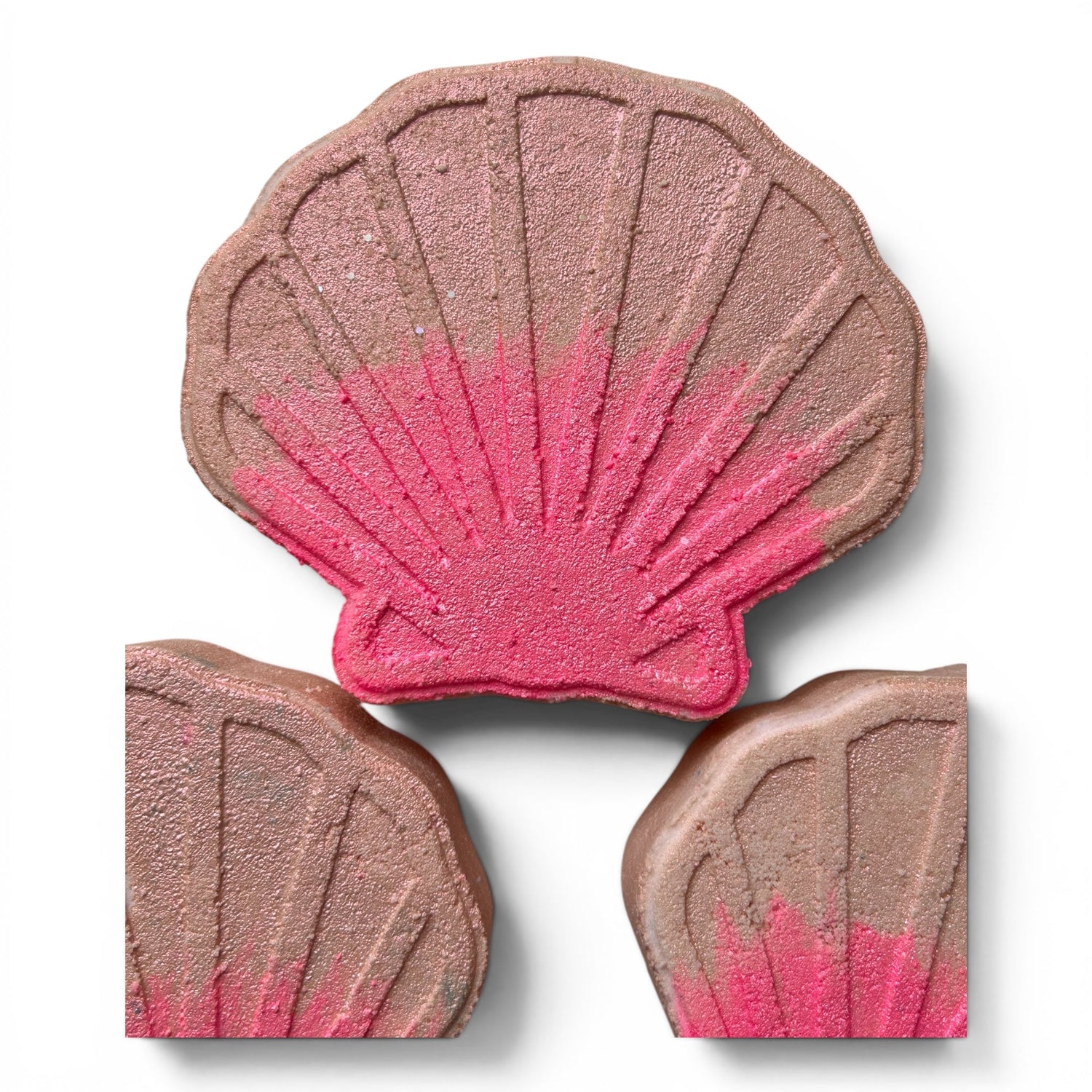 Shell-shaped bath bomb with pink swirl and brown shell segments, three-piece view