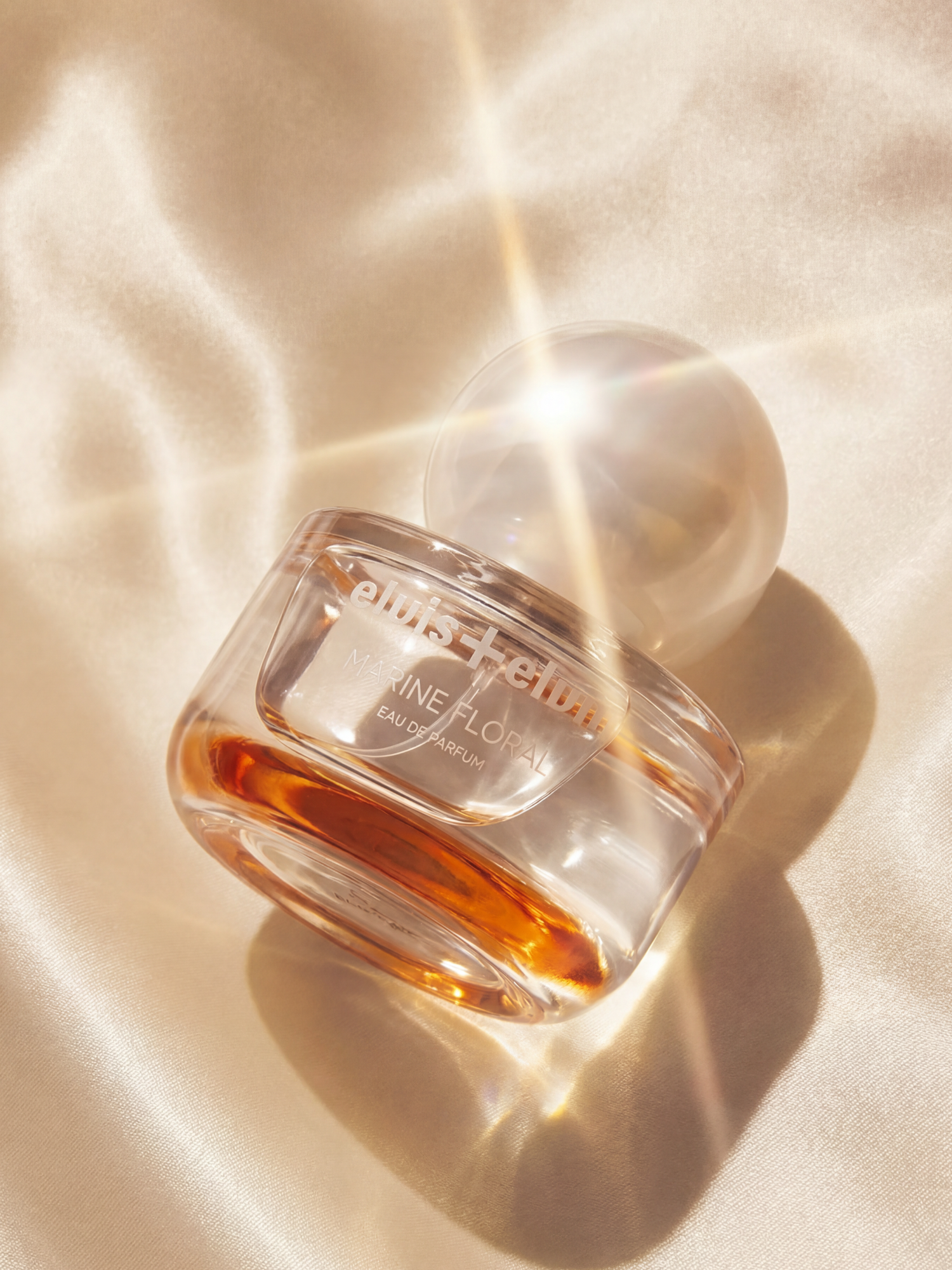 elvis+elvin Marine Floral eau de parfum bottle with amber liquid and rounded frosted cap