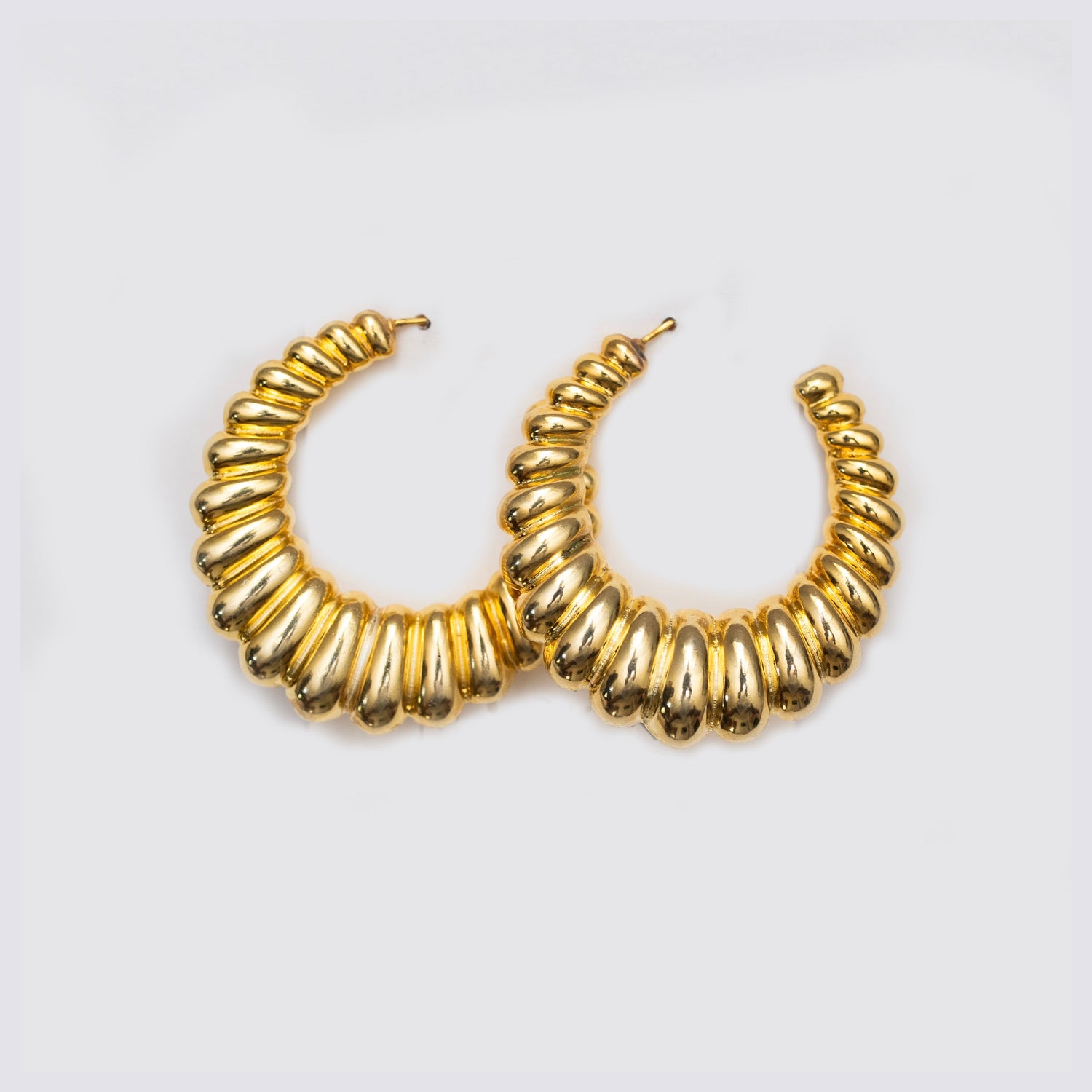 Gold spiral ribbed hoop earrings, front view close-up