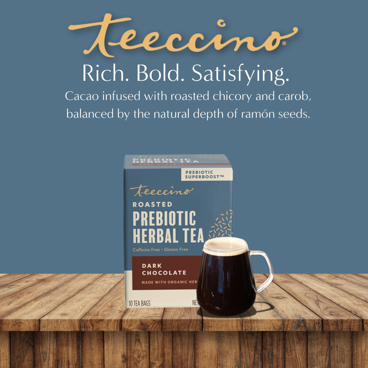 Roasted prebiotic herbal tea box with cup of dark tea on a wooden surface