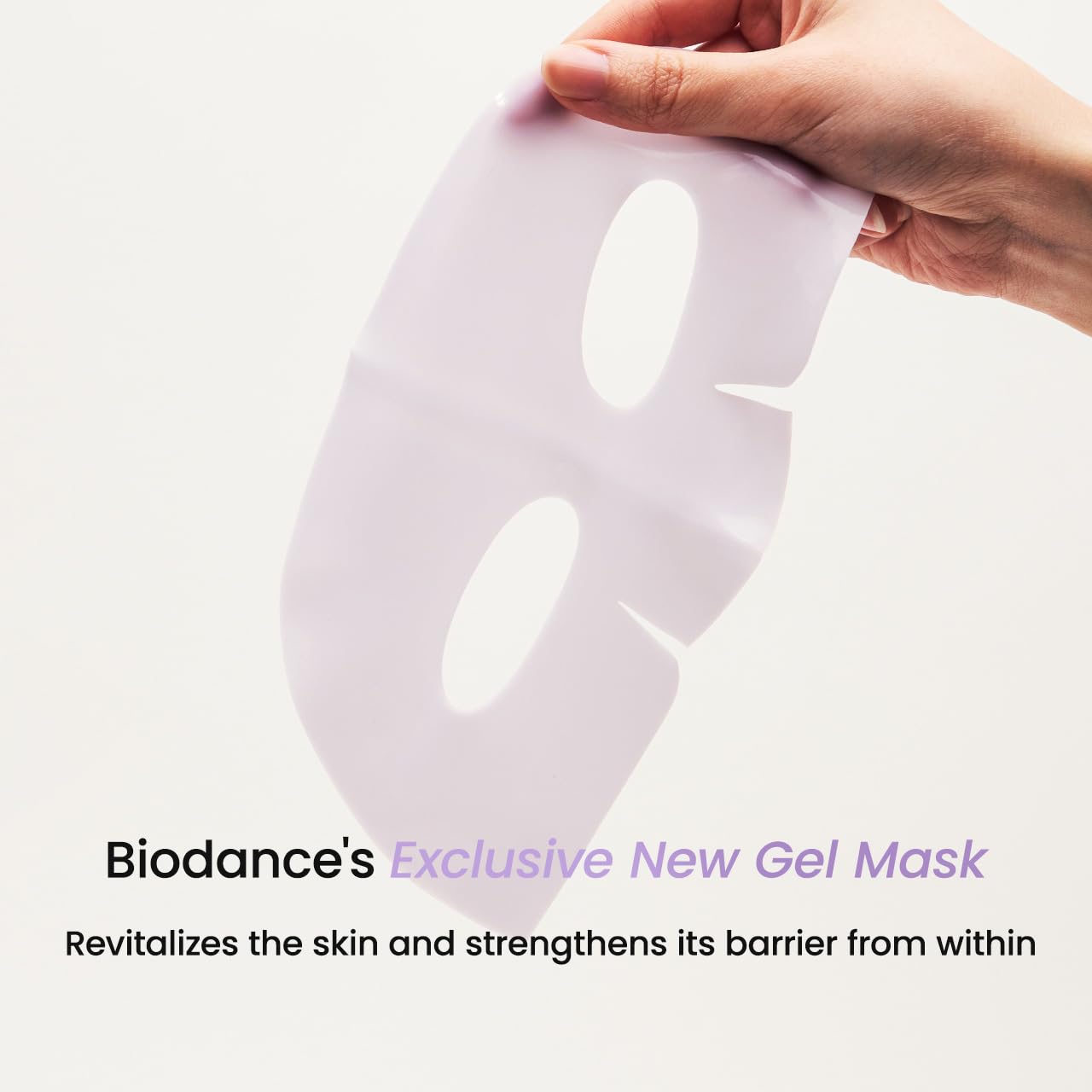 Facial sheet mask in hand, lavender with eye and mouth cutouts