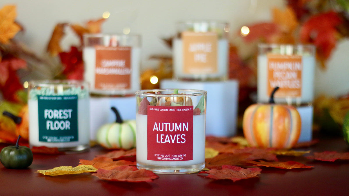 Autumn leaves scented candle in clear glass jar, red label visible