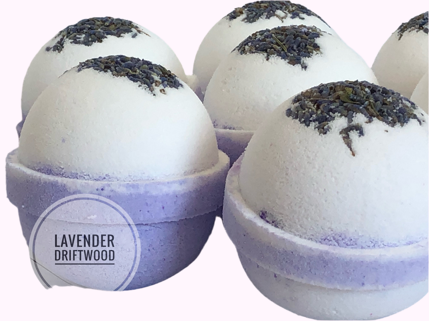 Lavender-scented bath bomb, white with purple band and dark speckled top.