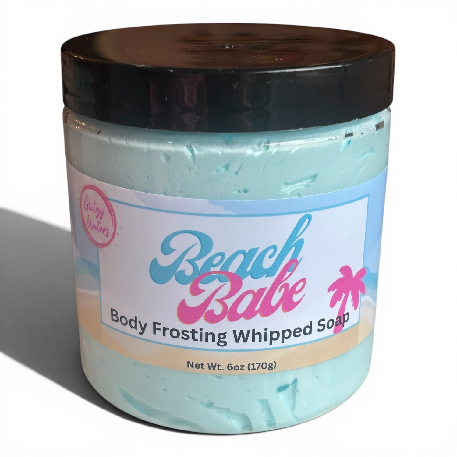 Aqua-blue whipped body soap jar with dark lid and smooth frosting swirl