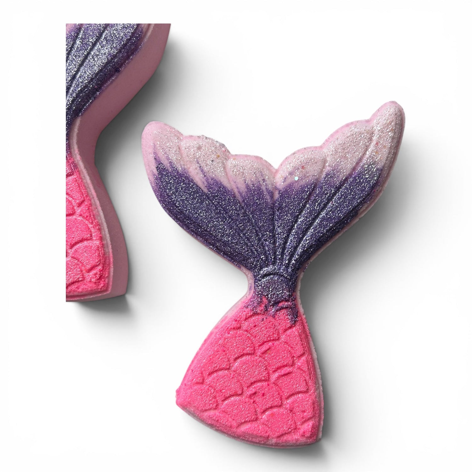 Mermaid tail bath bomb with pink base and purple glitter swirl on top