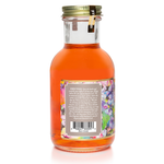 Diffuser oil bottle back view with directions label, barcode, gold cap, orange liquid