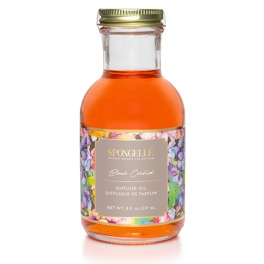 Black orchid diffuser oil in clear glass bottle with gold lid and orange liquid