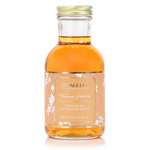 SPONGELLE tobacco vanilla diffuser oil bottle with amber liquid, gold cap