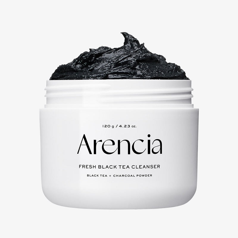 Arencia cleanser jar with black tea foam piled on top