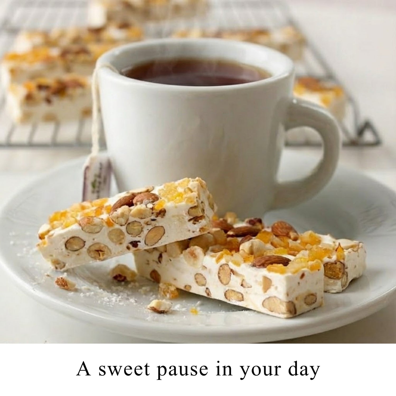 Orange peel nougat brittle pieces on a plate with coffee in a white mug.