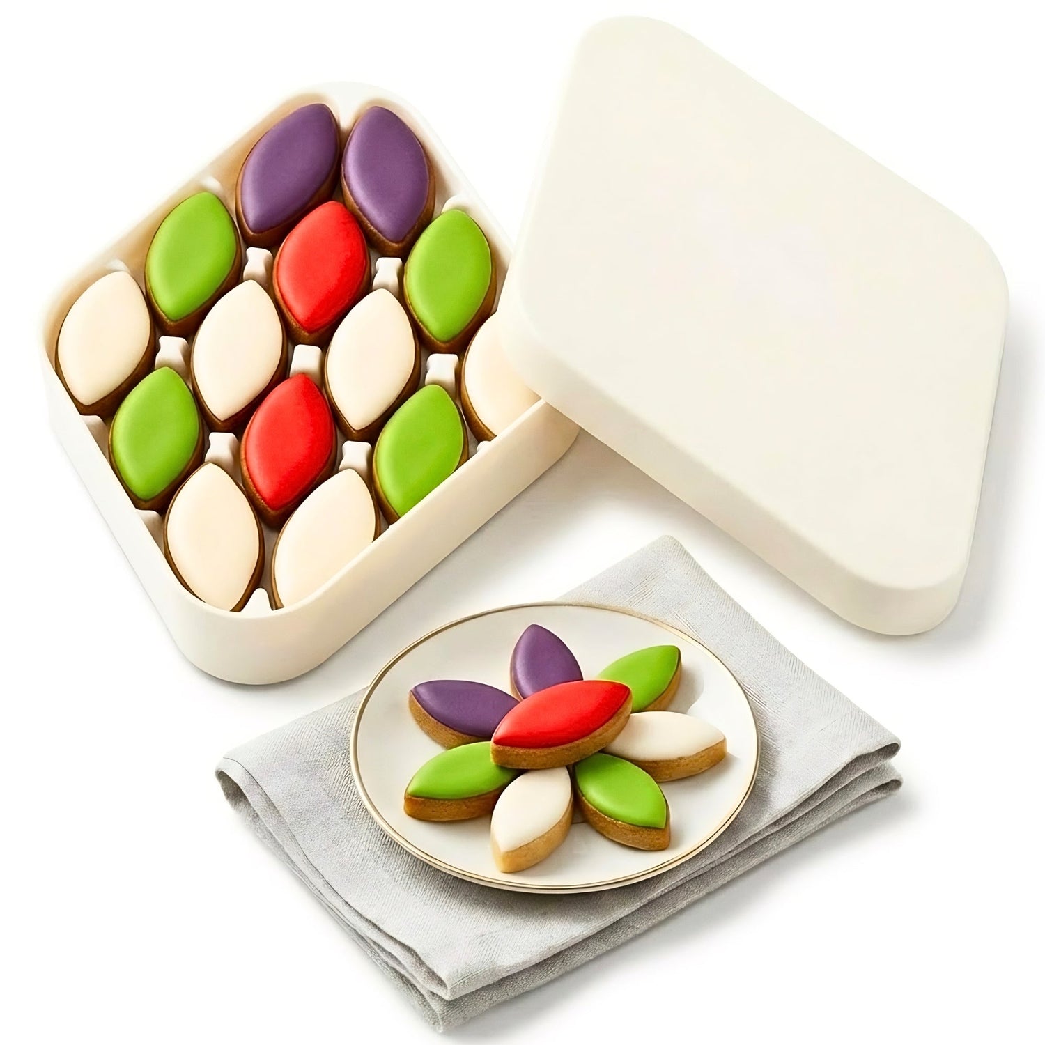 Assorted almond calissons in an open white gift box, white, red, green, and purple pieces