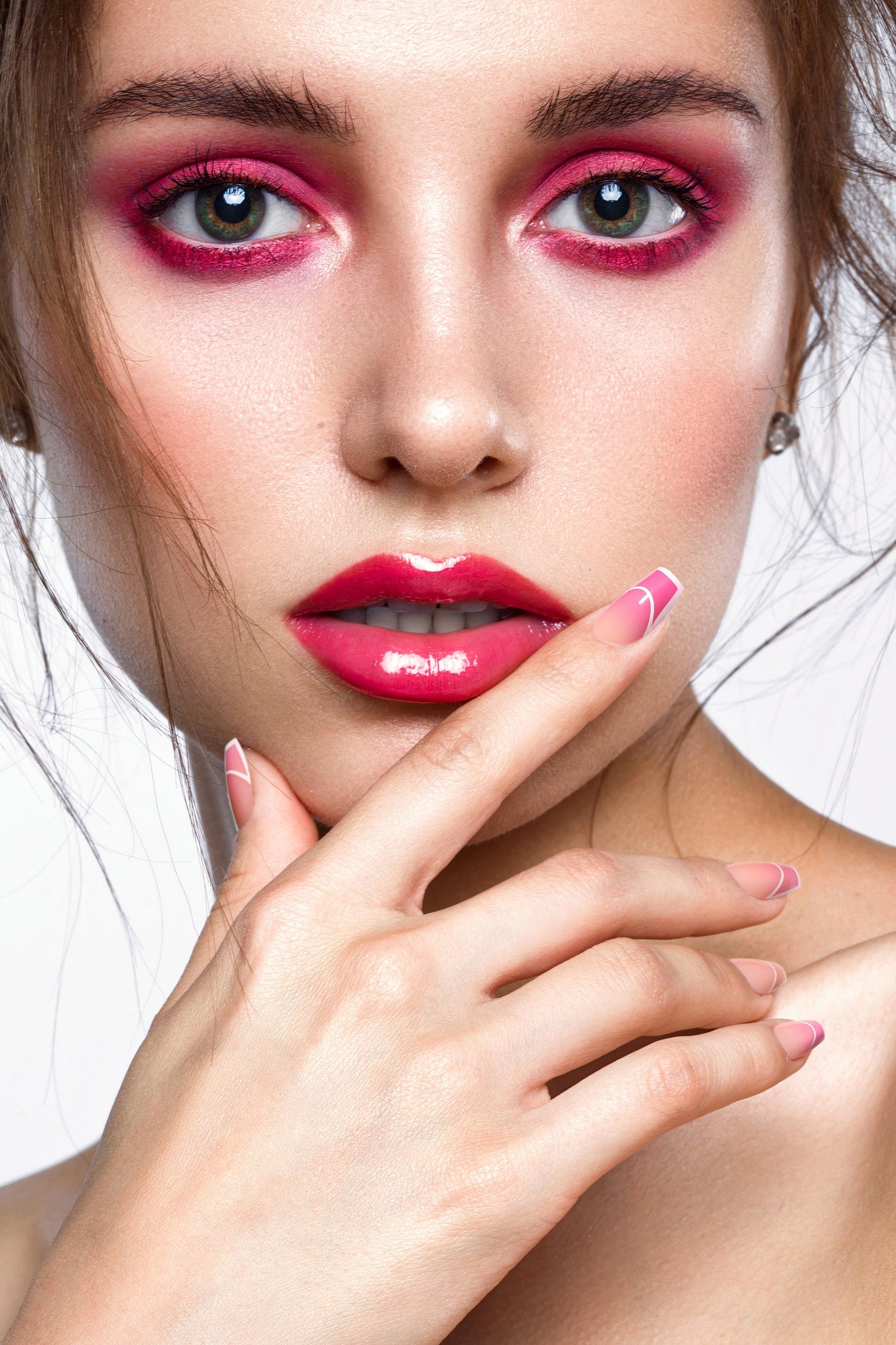 Close-up of short oval press-on nails in glossy pink with curved French-tip lines
