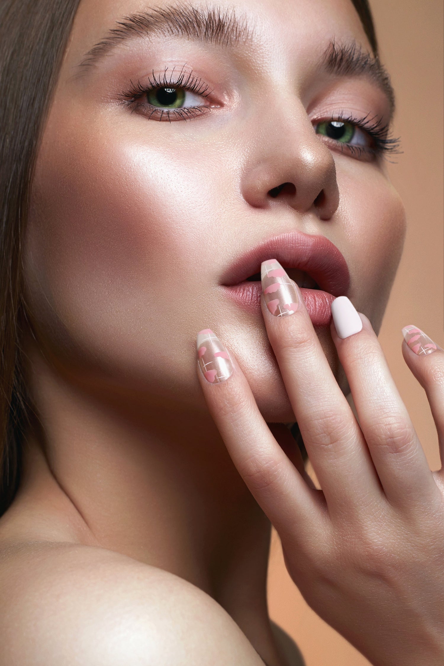 Long almond press-on nails with clear pink pattern and white tips