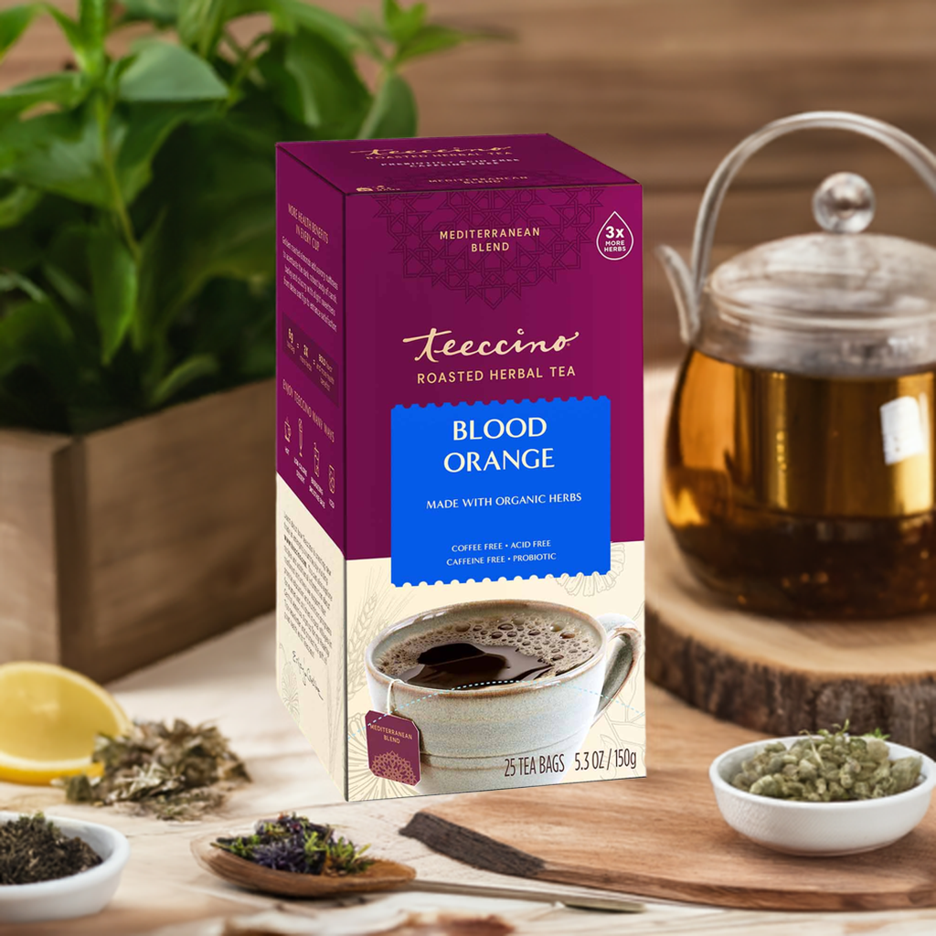 Roasted herbal tea box with Blood Orange label beside brewed cup and herbs