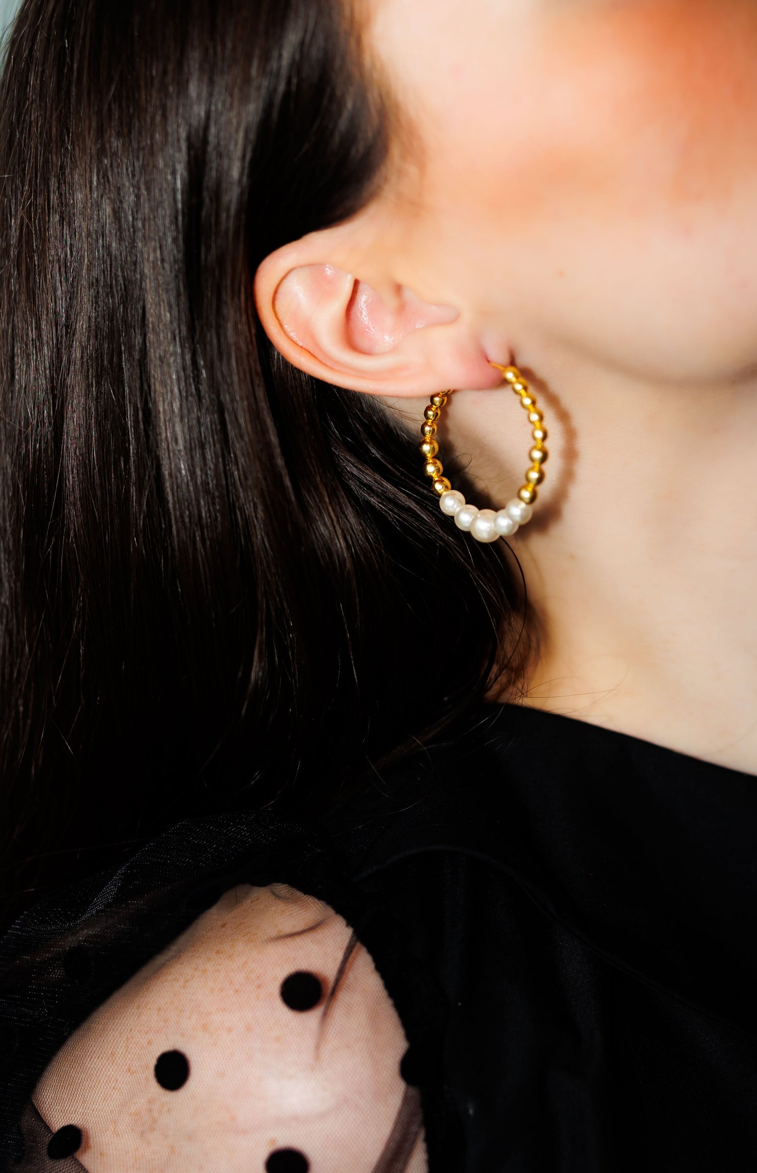 Gold hoop earrings with pearl accents and textured bead details