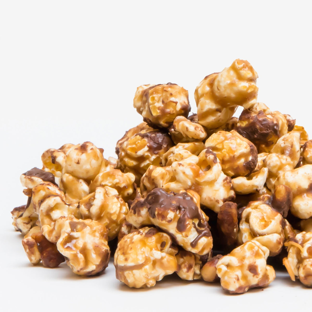 Turtle popcorn clusters with caramel and chocolate coating, golden and dark brown