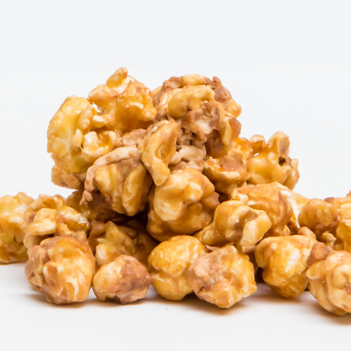 Caramel popcorn kernels with creamy caramel coating, piled high