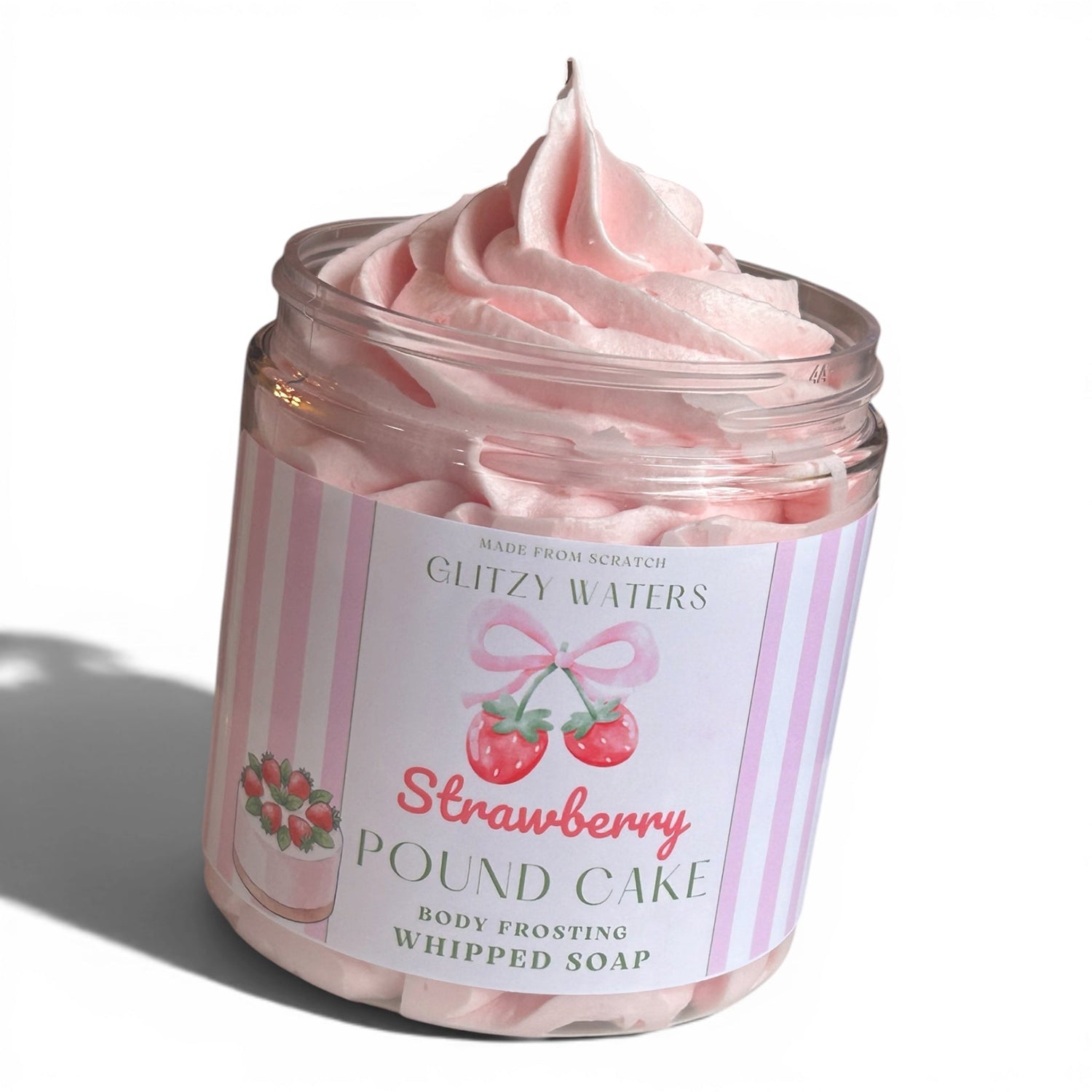 Pink whipped body soap in a clear jar with a pink swirl on top