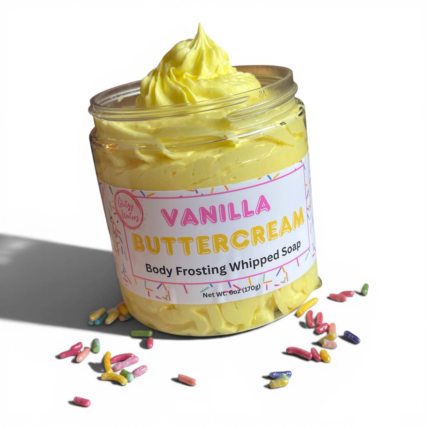 Vanilla buttercream body frosting whipped soap in clear jar with yellow swirl and label
