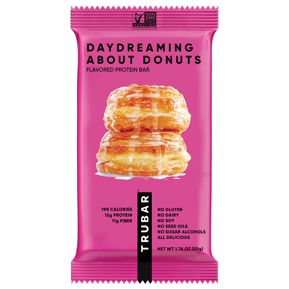 TRUBAR plant-based protein bar, pink wrapper with donut stack graphic.