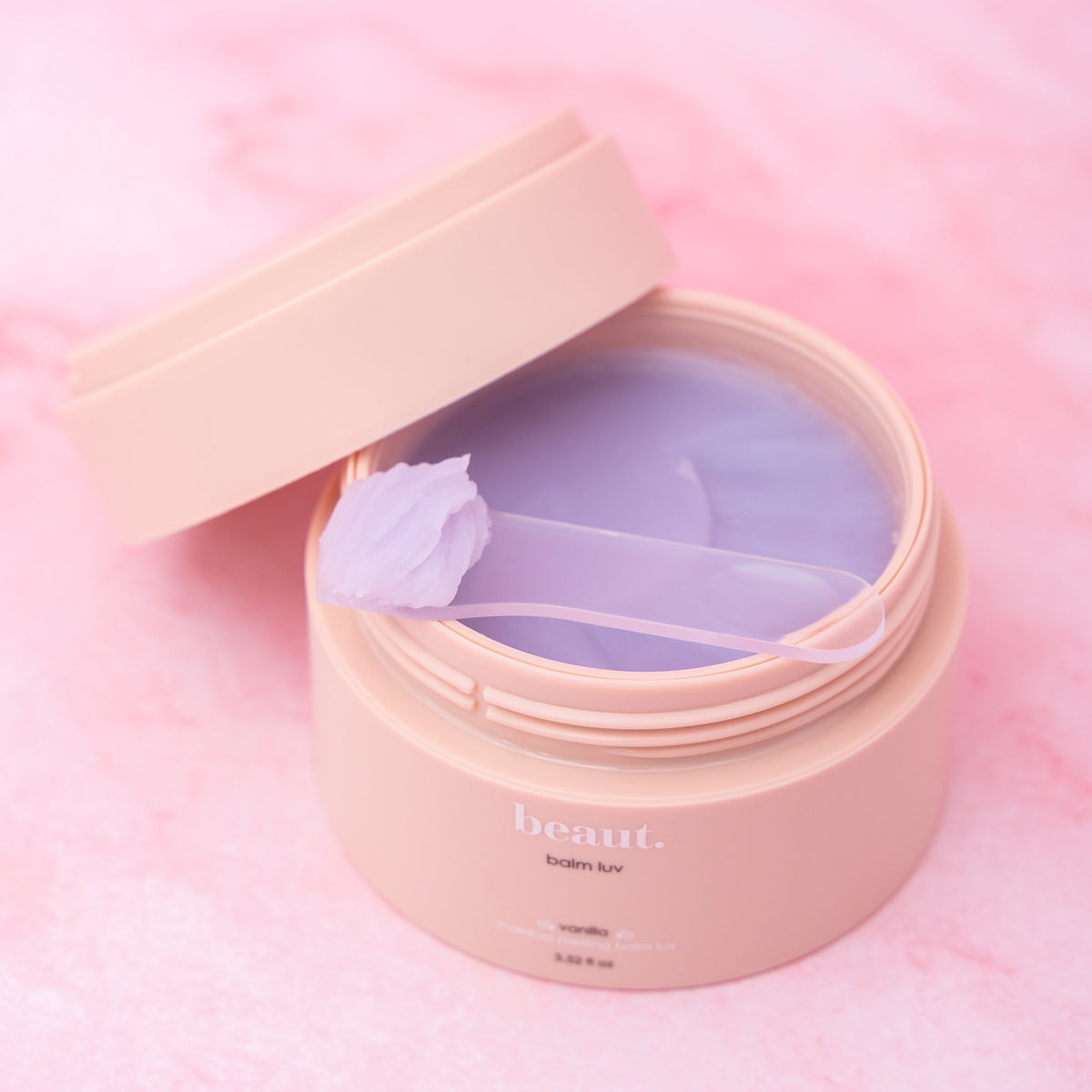 beaut. balm luv jar with open lid, lavender-toned balm gel inside