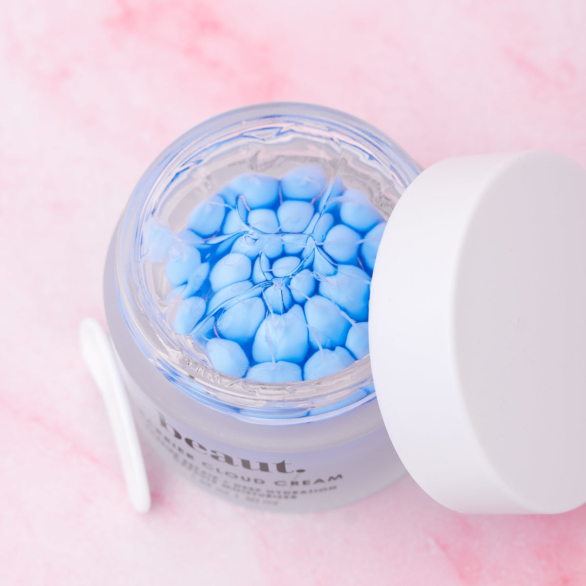 beaut. Barrier Cloud Cream jar open, showing blue capsule gel beads inside