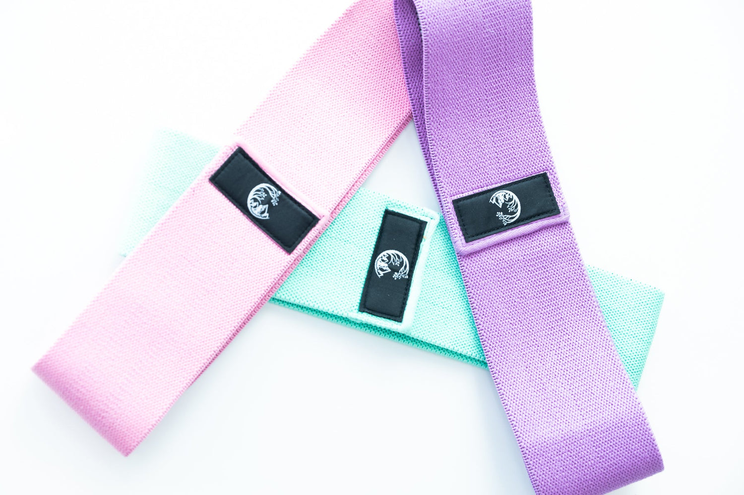 Booty bands in pink, light teal, and purple, overlapping wide elastic straps