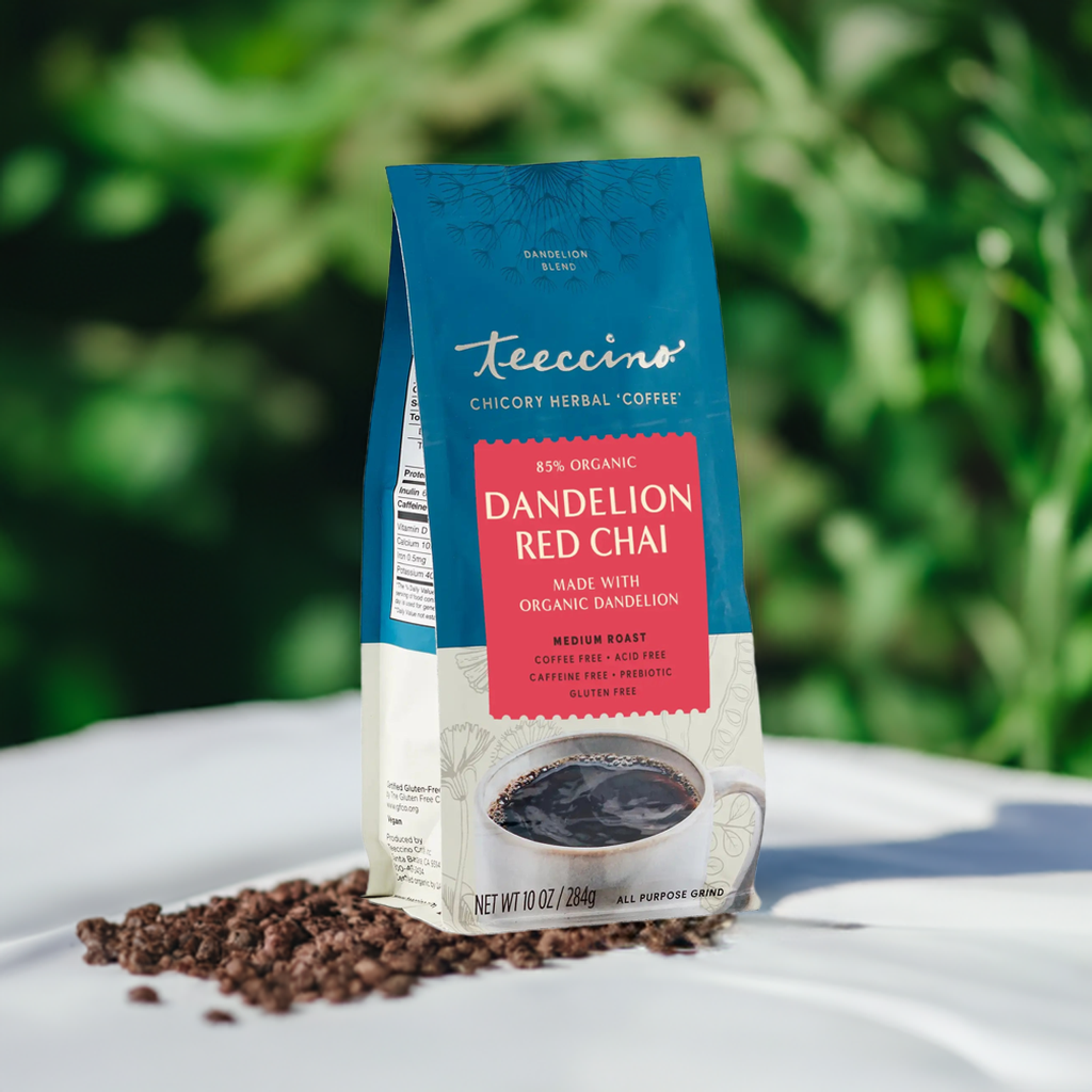 Dandelion red chai herbal coffee pouch with teal top and red label, with grounds on tray.