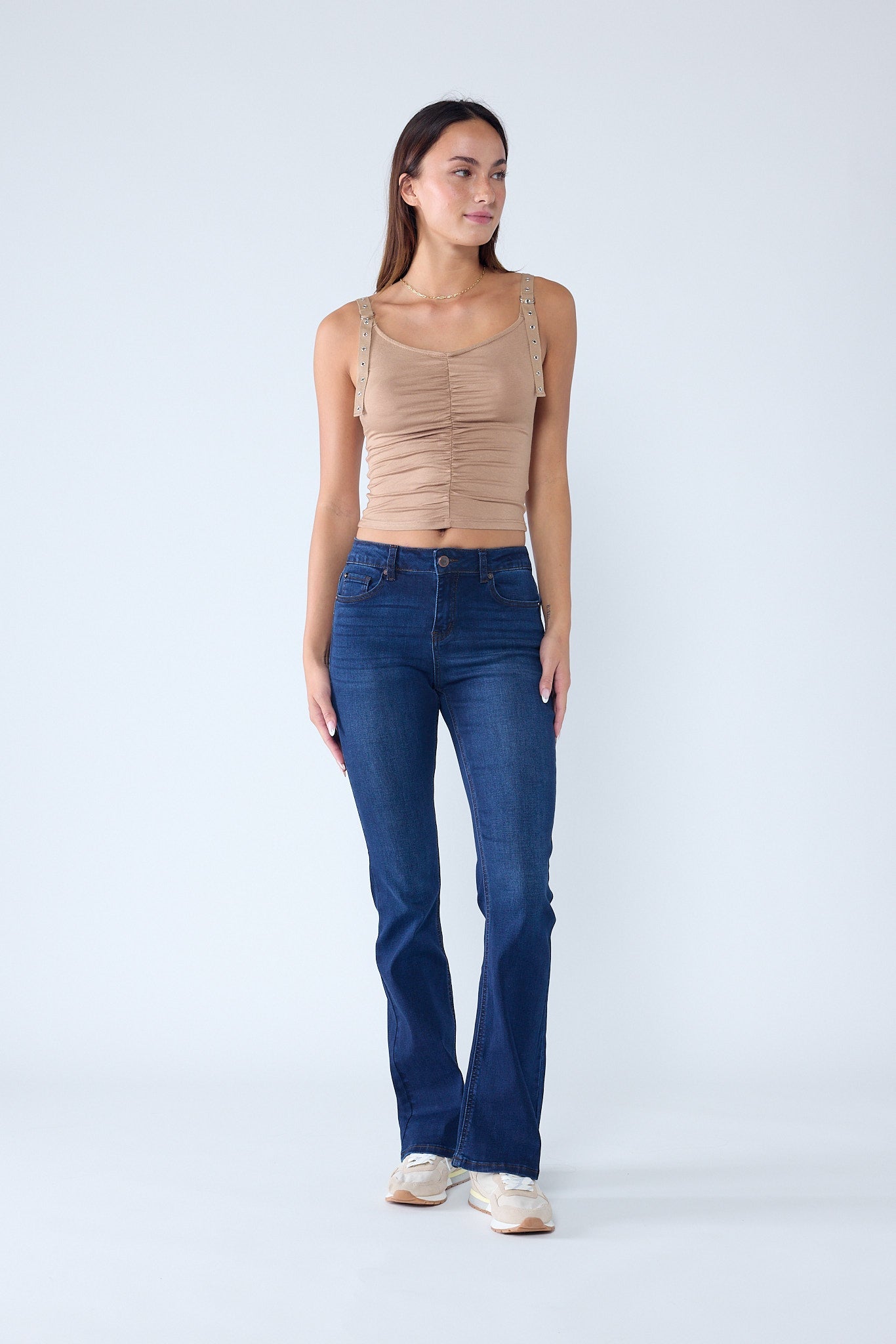 High-rise medium blue bootcut jeans with five pockets and button-and-zip fly.
