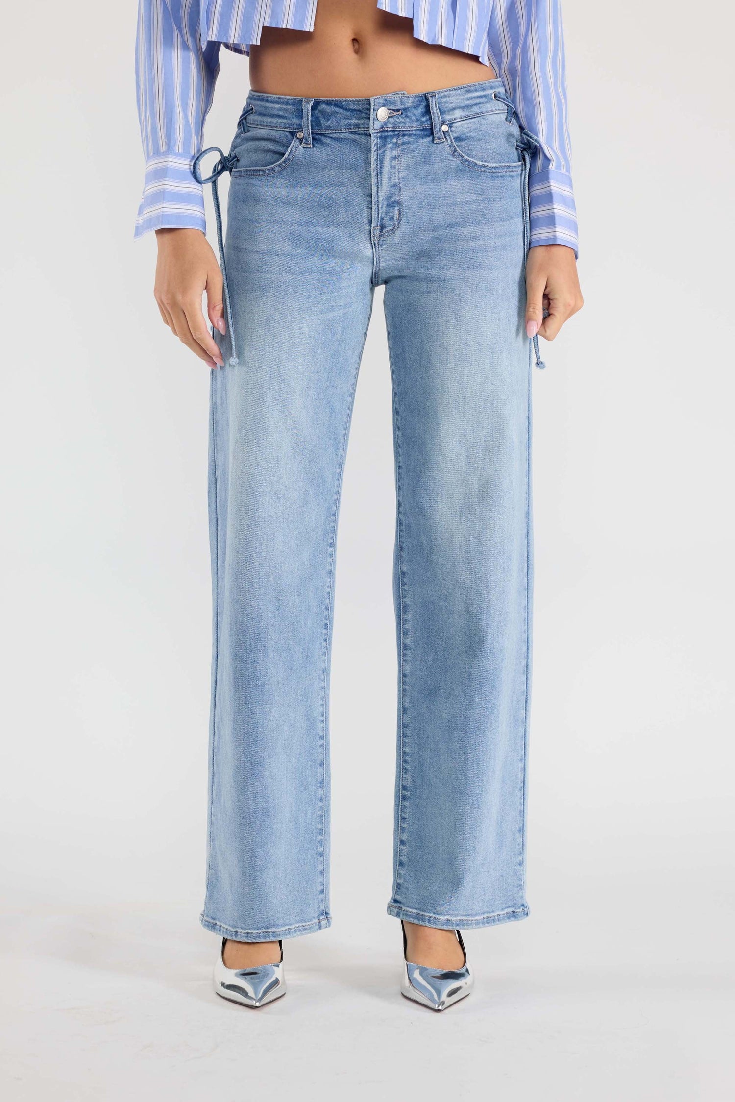 Medium-wash relaxed straight denim jeans with belt loops and side lace tie detail
