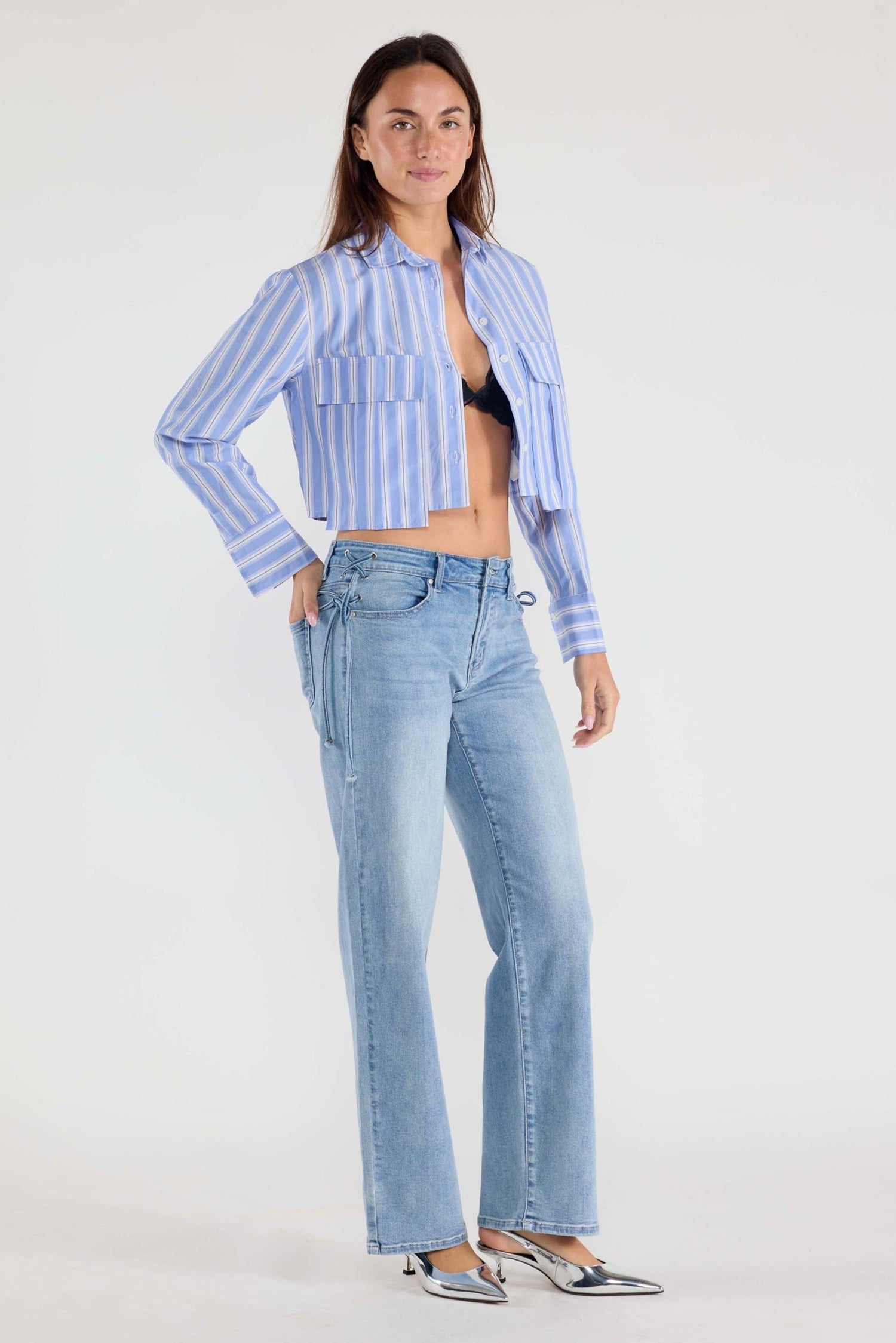 Medium-wash denim jeans with relaxed straight legs and side lace ties at waist