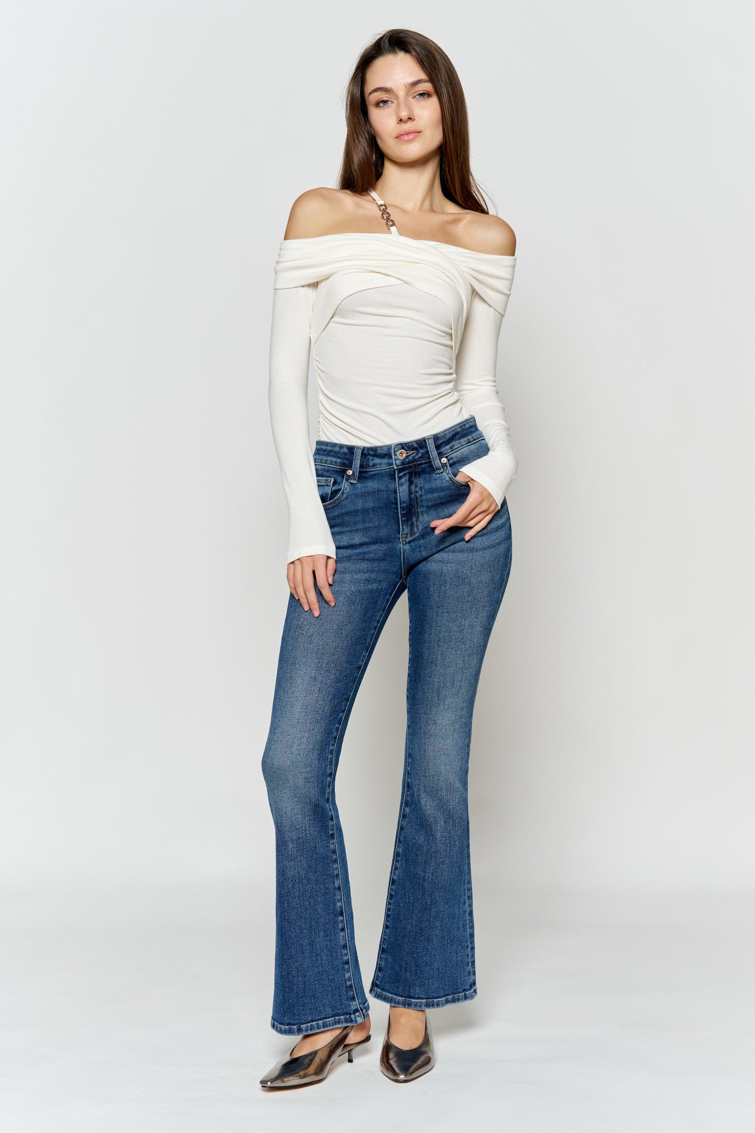 High-rise bootcut jeans in medium-wash blue with button, belt loops, and five pockets