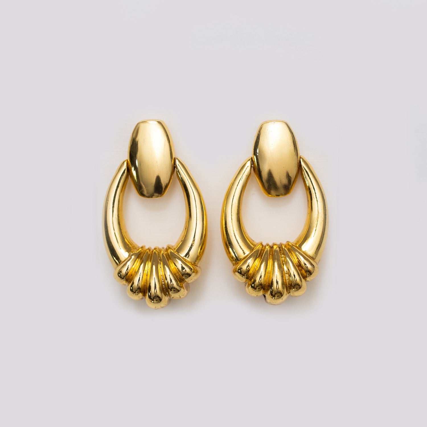 Gold-tone sculpted hoop earrings with layered fringe detail
