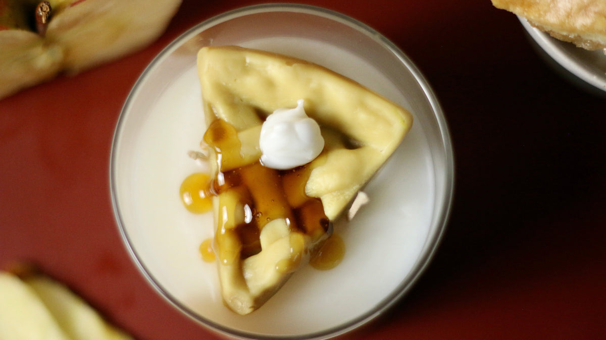 Apple pie scented wax in clear jar with white dollop and caramel-like drips