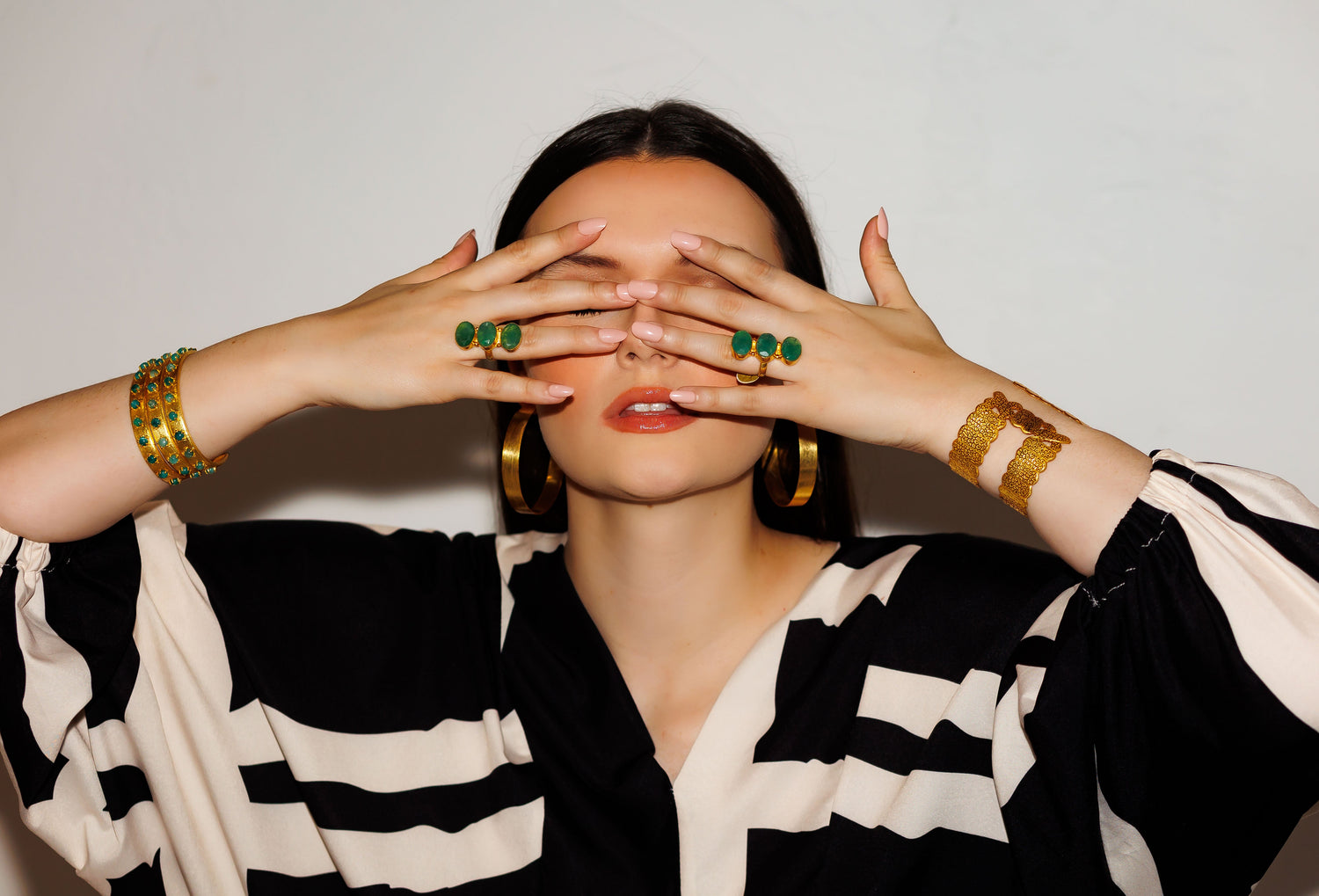 Gold hoop earrings worn by model, oversized oval hoops with polished finish