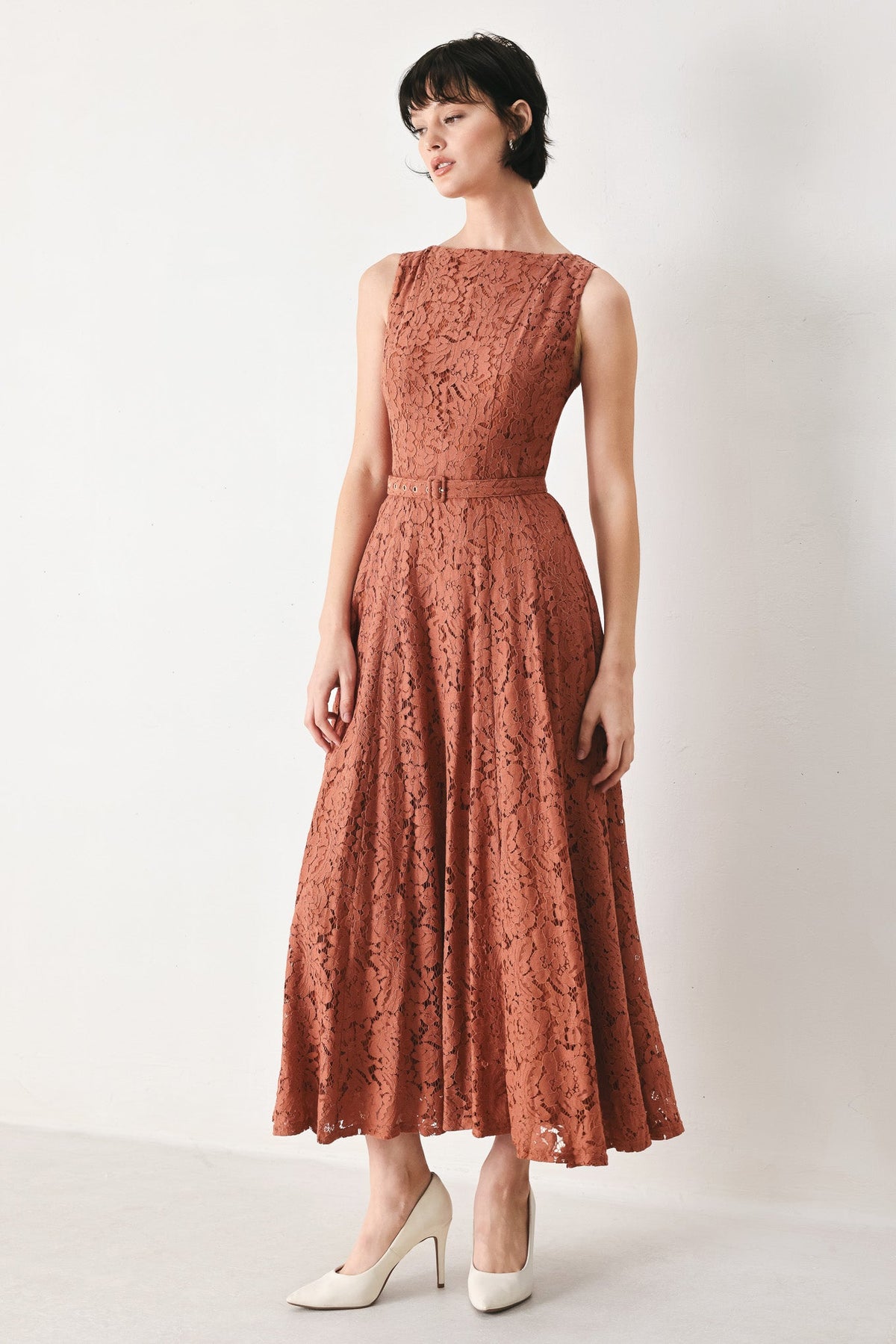 Rust lace midi dress with sleeveless high neckline and fitted waist, tiered skirt.