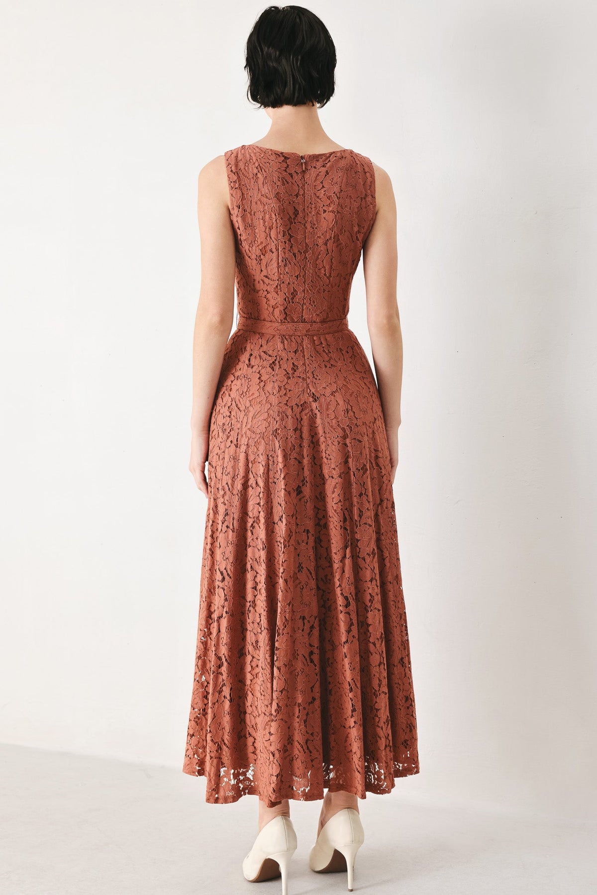 Rust lace midi dress, sleeveless with open back and fitted bodice, tiered skirt.
