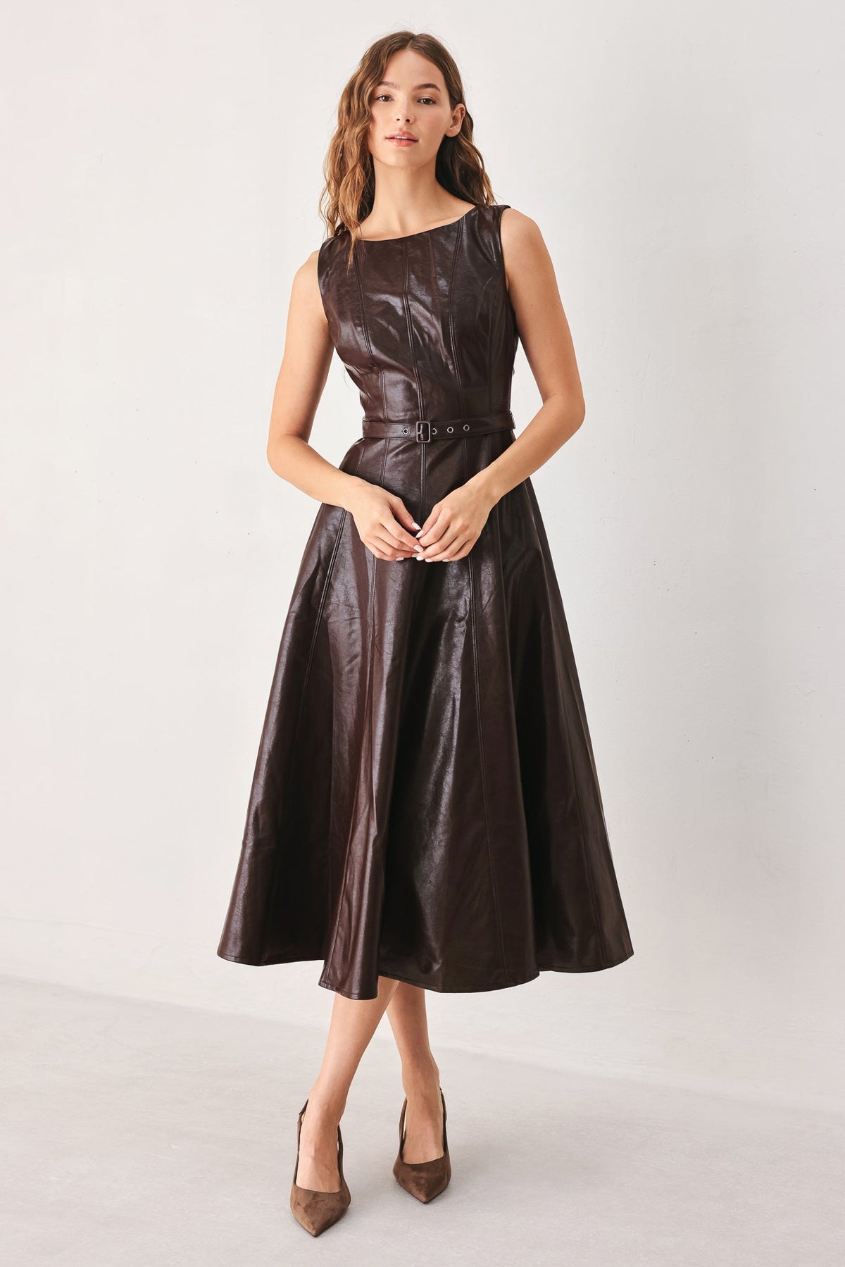 Dark brown faux leather midi dress with sleeveless crew neckline and belted waist seam.