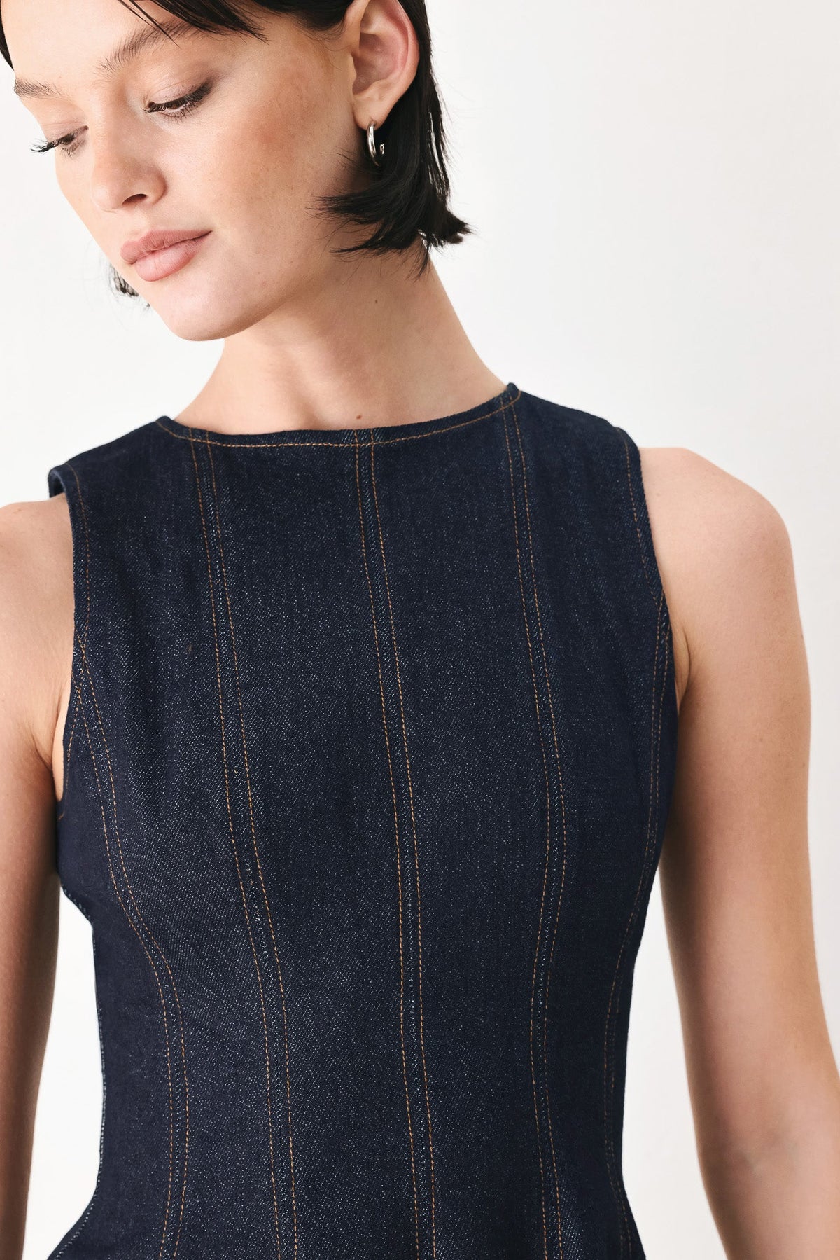 Dark denim sleeveless bodice with high neck and vertical contrast stitch stripes