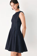 Dark denim sleeveless mini dress side view, high neck and flared A-line skirt