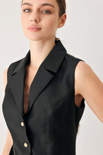 Black sleeveless woven mini dress with point collar and gold button placket