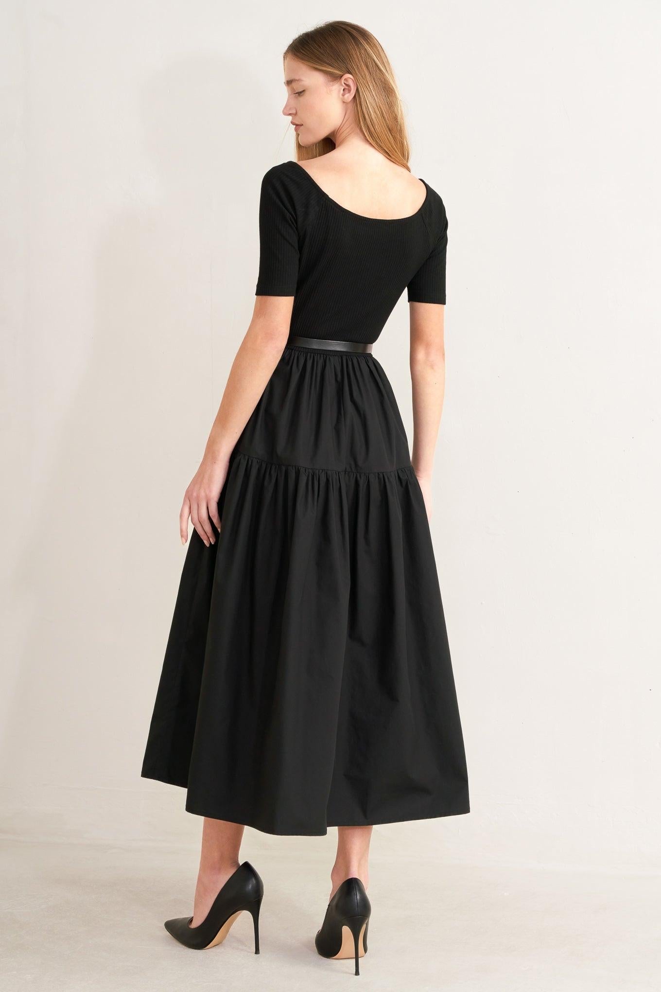 Black midi dress, back view: short sleeves, tiered skirt, and waist belt with buckle