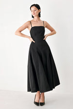 Black midi dress with thin shoulder straps and gathered waist, full midi skirt