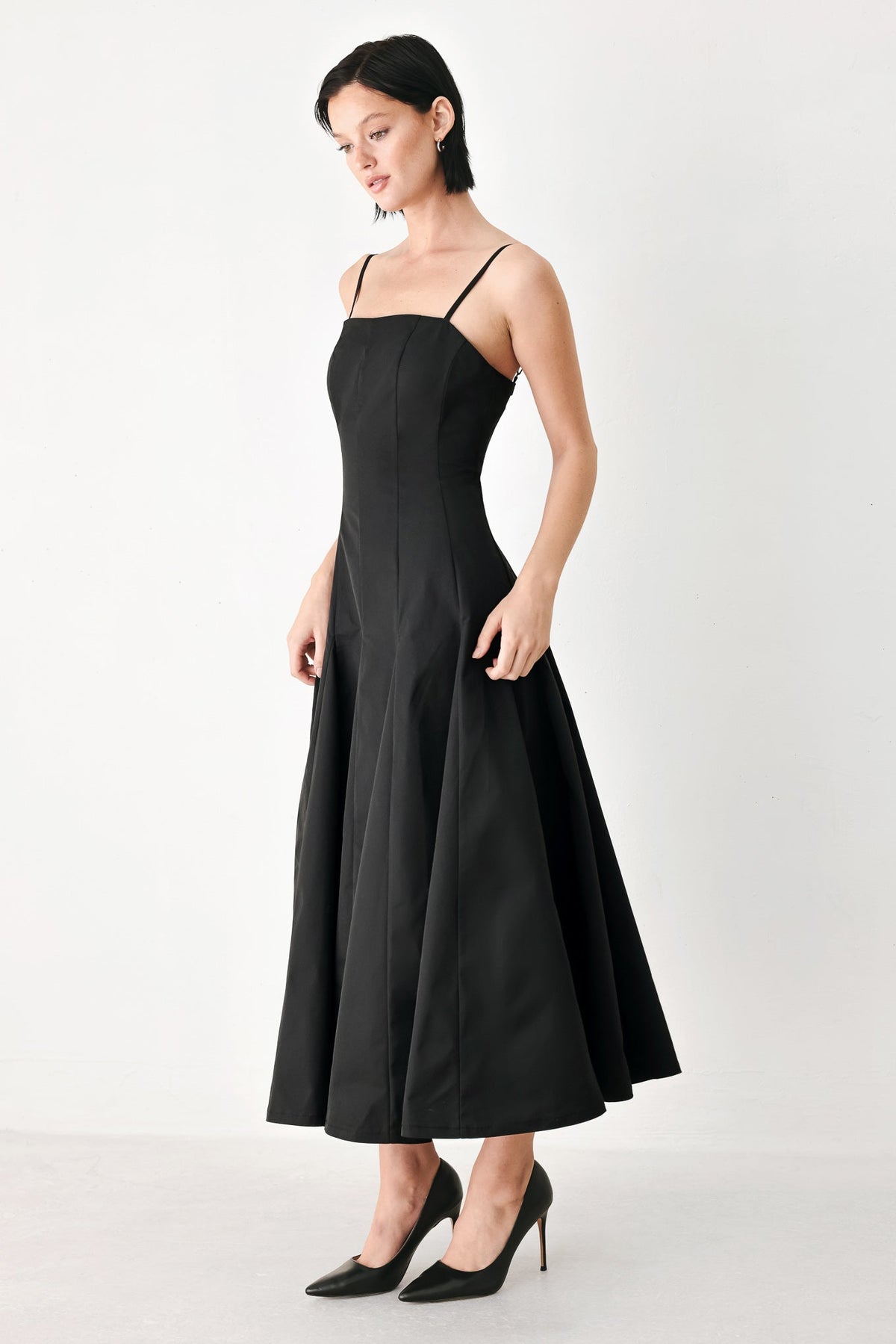 Black midi dress with spaghetti straps and A-line skirt, sleeveless fitted bodice