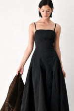 Black midi dress with spaghetti straps and square neckline, pleated full skirt