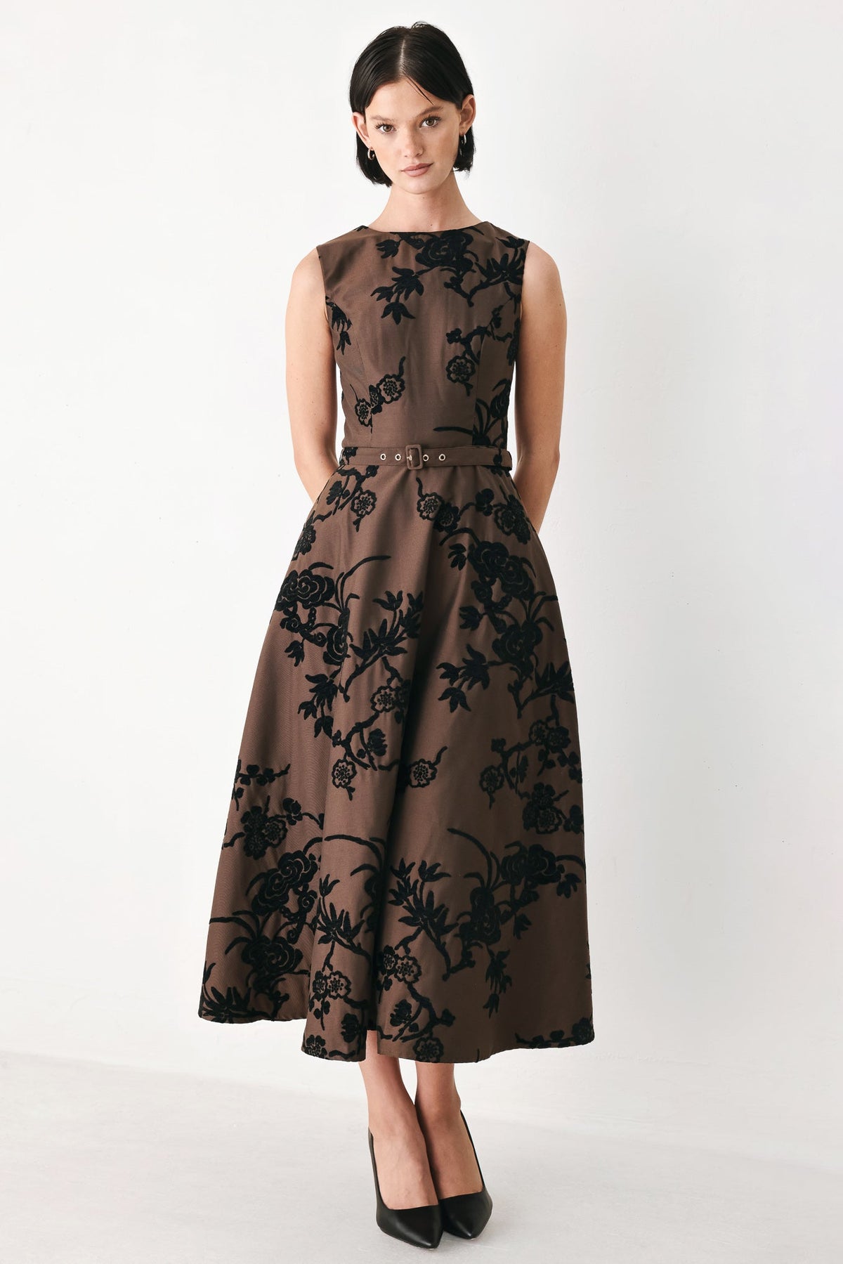 Brown sleeveless woven midi dress with black floral pattern and waist belt