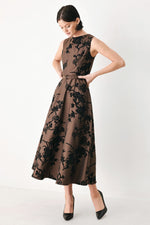 Brown sleeveless midi dress with black floral print and fitted waist belt, side view