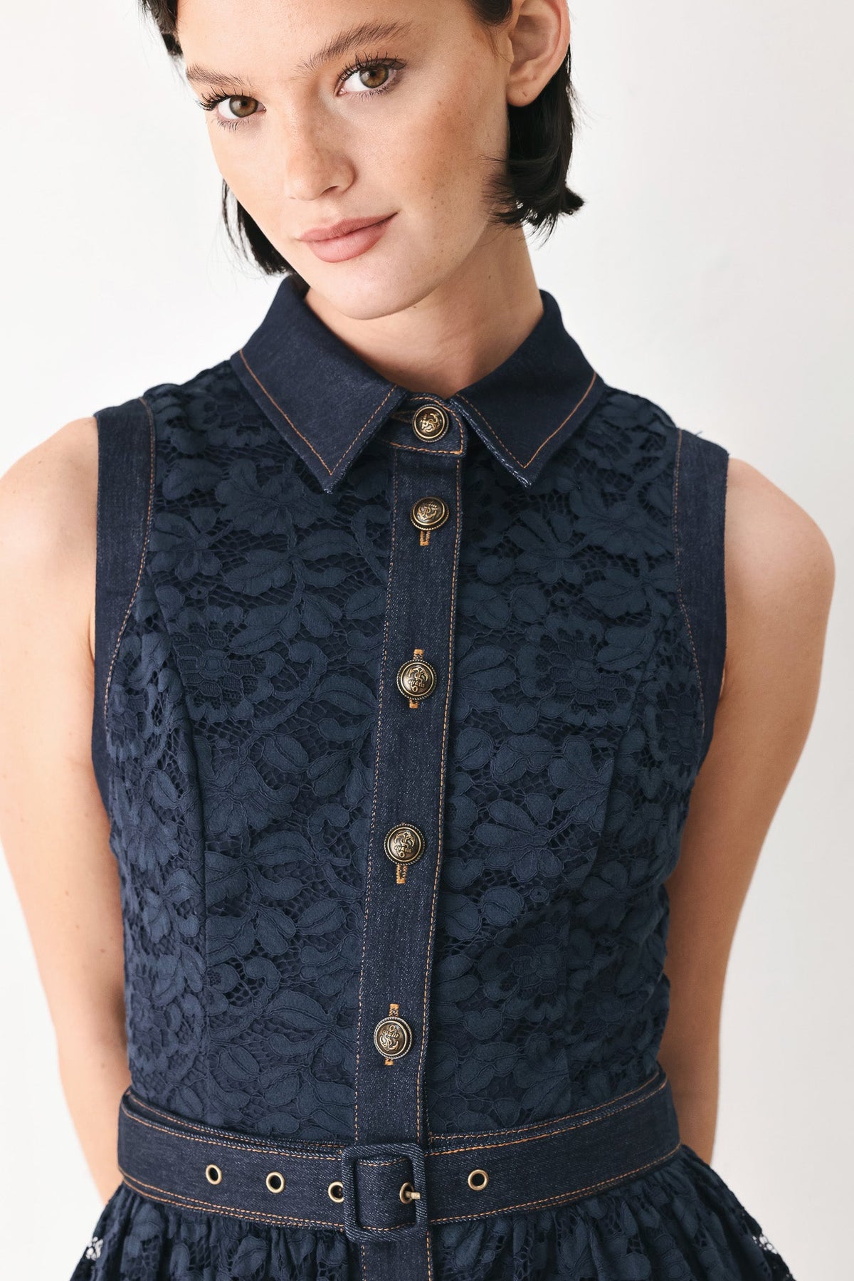 Navy sleeveless lace midi dress close-up: high collar, gold buttons, waist belt