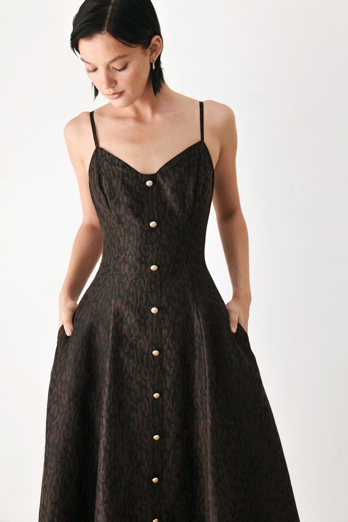 Dark patterned sweetheart midi dress with spaghetti straps and gold button placket